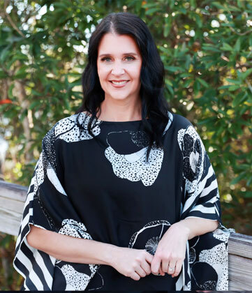 Professional female dentist smiling at Niceville dental practice.