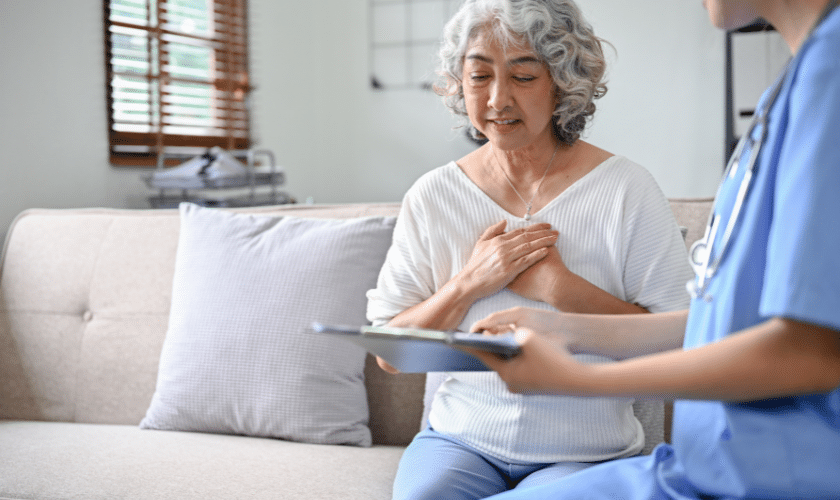 Healthcare provider in blue scrubs consulting with senior patient about nursing care treatment in Niceville.