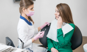 Dentist consulting with patient about emergency dental treatment in Niceville office.
