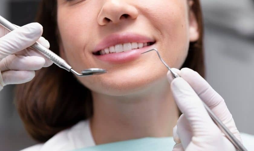 Dentist examining patient's smile during cosmetic dental consultation in Niceville.