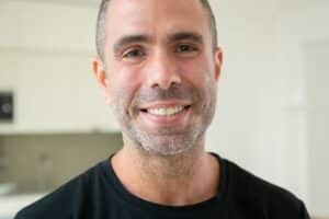 Smiling man with cosmetic dental work, demonstrating results of adult smile enhancement.