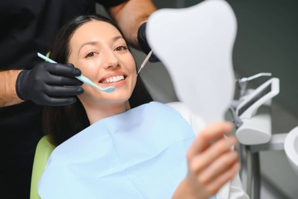 Patient smiling during cosmetic dental restoration treatment with dentist in Niceville, Florida.