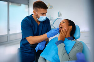 Dentist examining patient's teeth during dental checkup in Niceville office.