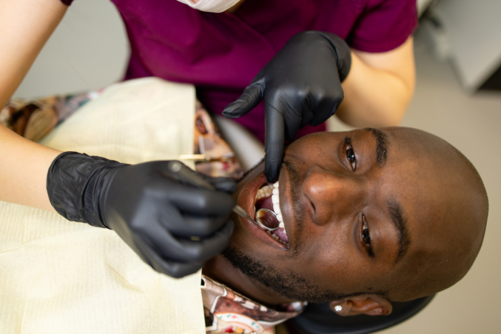 Dentist examining patient's teeth during oral examination at Niceville dental practice.